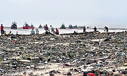 Beach litter piles up at Bengre End Point as river waste washes ashore