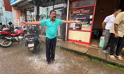 Karkala Municipality roof water drainage issue: Former councillor stages unique protest by standing under rainwater