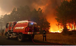 90,000 people flee raging wildfires in France and Spain, some escaping by boat