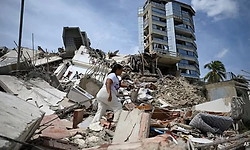 "He is in there": Mother searches with bare hands for son buried under rubble