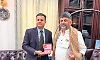 Abharan MD Dr Pratap Madhukar Kamath presents commemorative gold coin to DK Shivakumar
