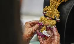 Gold could retest record highs as traders eye Powell's speech, RBI policy: Analysts