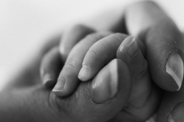 mother-holding-babies-hand-black-and-white-photography.jpg