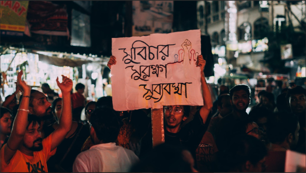 A student holding placard 'Justice, Protection and Proper Governance' (Credit: Debojyoti Chatterjee)